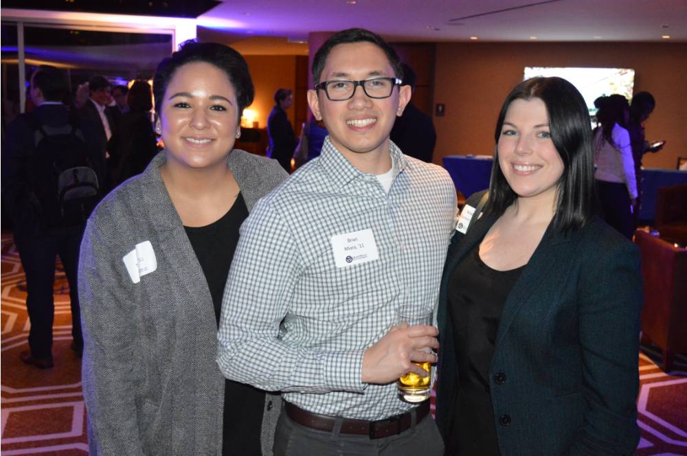 Three alumni pose for a photo together at the Chicago Reception